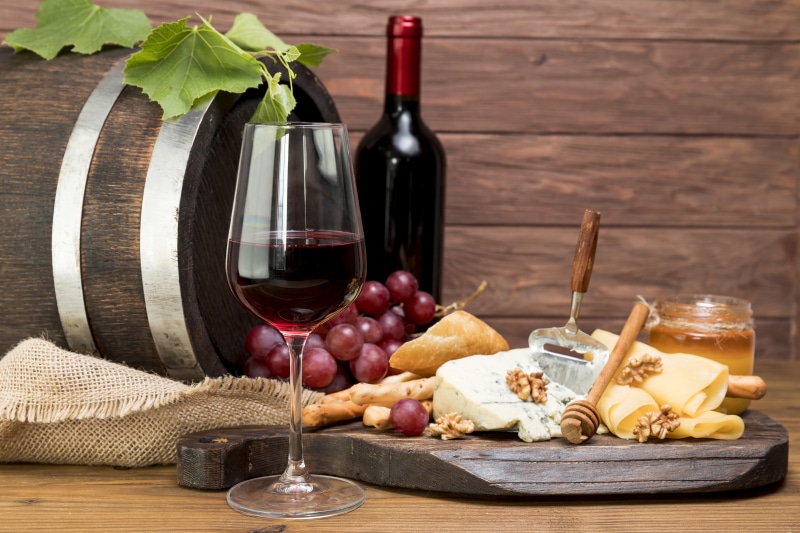 Wine, Cheese, Grapes, and Barrel