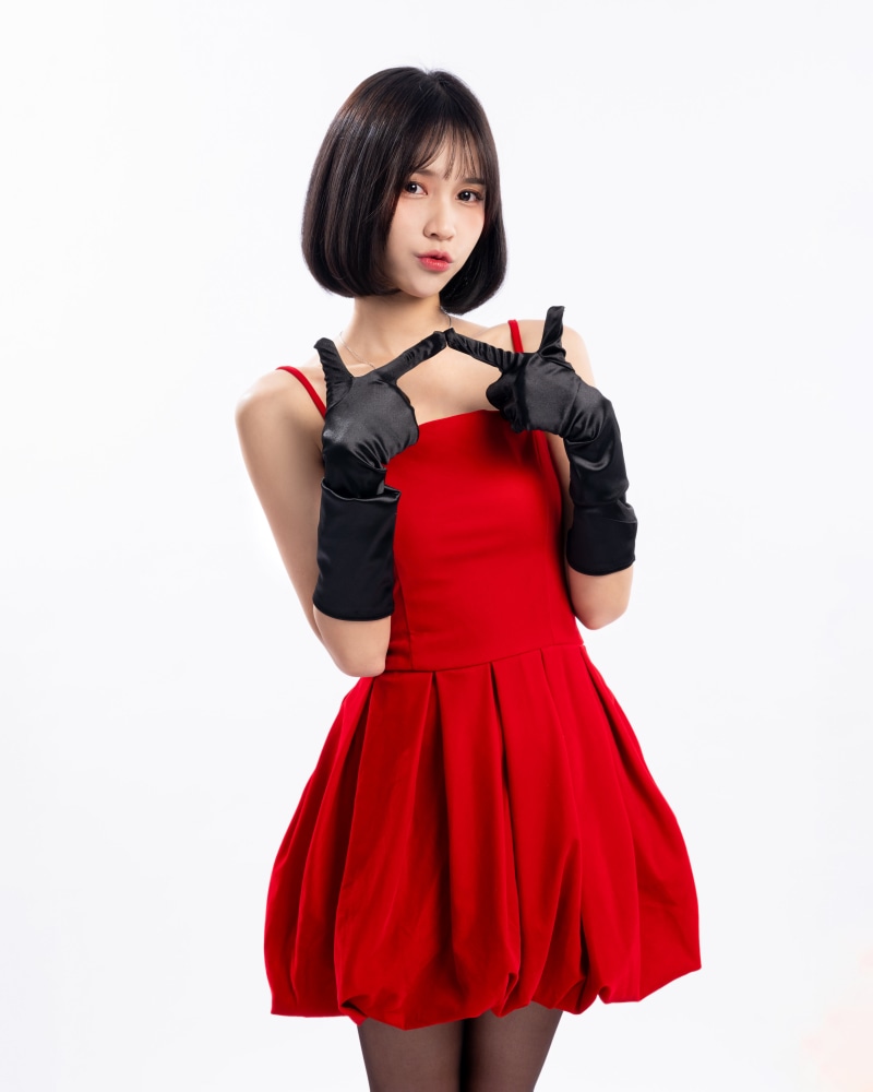 Asian woman in red dress and black gloves posing
