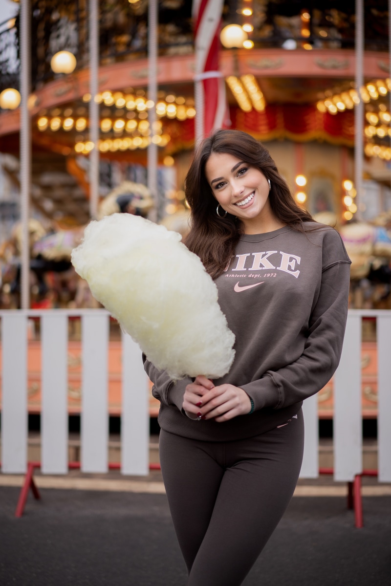 Anastasija with cotton candy at a carousel