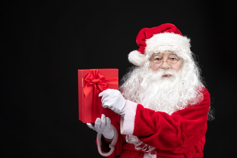 Santa Claus holding a red gift box