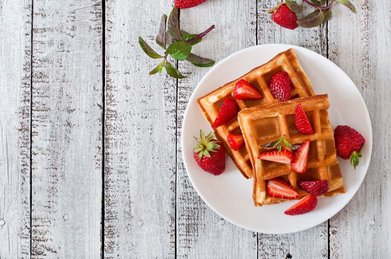 Waffles with strawberries on a white plate