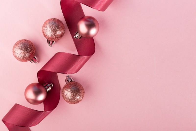 Christmas Ribbon and Balls on Pink Background