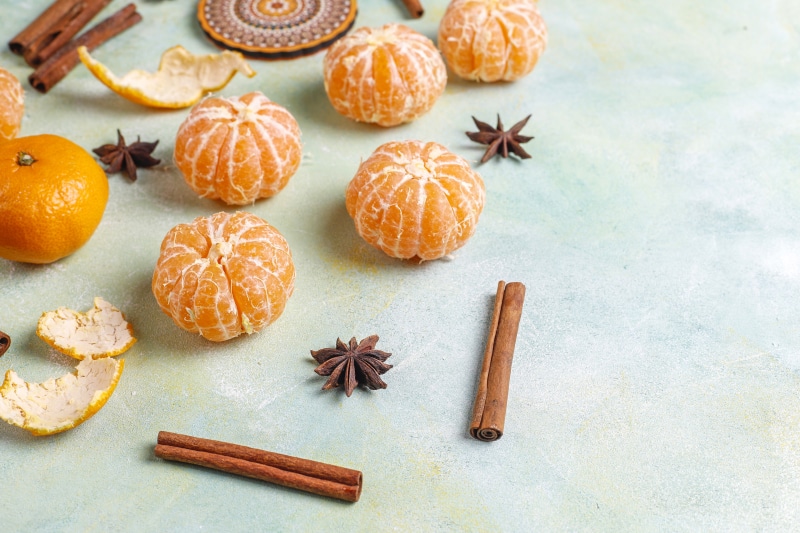 Mandarine, Cinnamon, and Star Anise on a Textured Surface