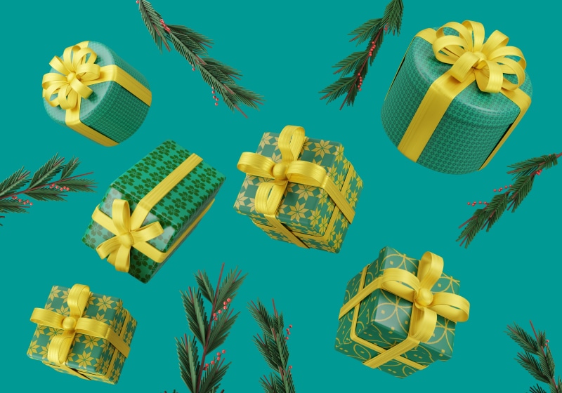 Christmas gifts and pine branches on a teal background