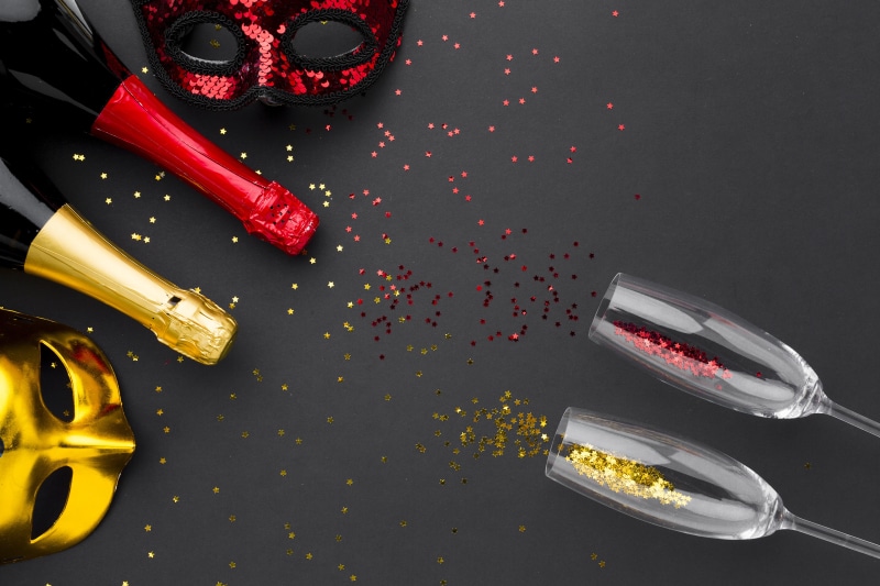 Champagne bottles, masks, and confetti