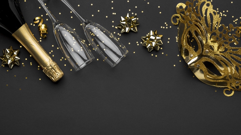 Champagne bottle, glasses, mask, and star decorations