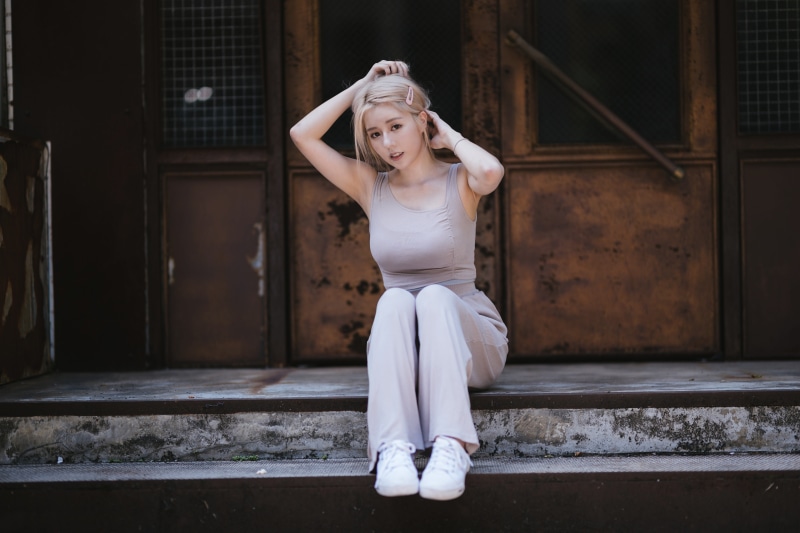 Asian woman sitting on steps