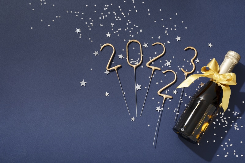 Champagne bottle with 2023 sparklers and confetti