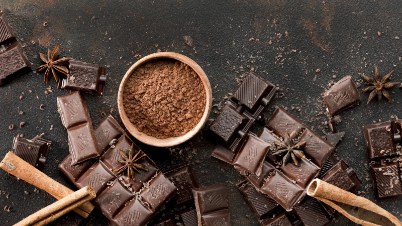 Chocolate bar, cocoa powder, cinnamon sticks, and star anise