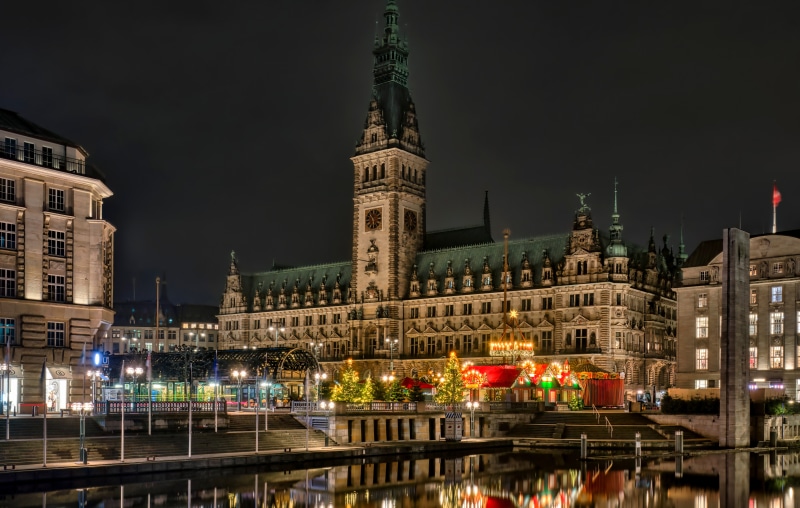 Hamburg City Hall at night with Christmas market
