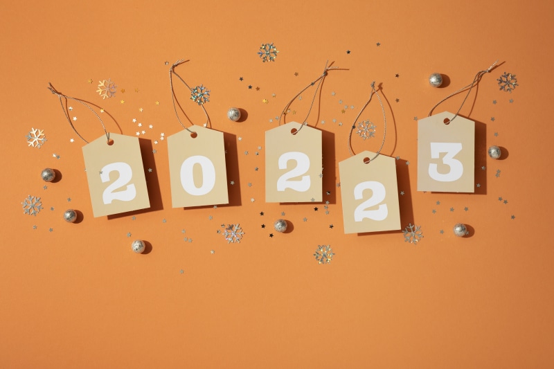 Tags with numbers 2023 and Christmas decorations