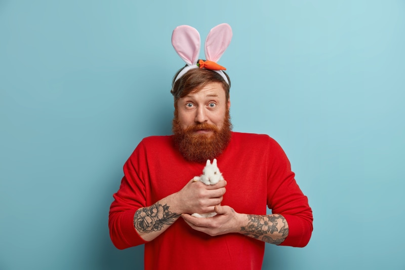 Man with bunny ears holding a rabbit