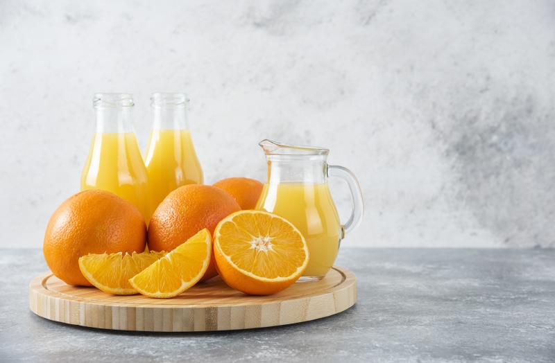 Oranges and orange juice in bottles and jug