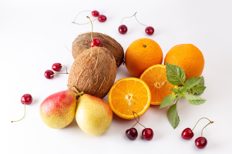 Oranges, Coconuts, Pears, and Cherries on White Background