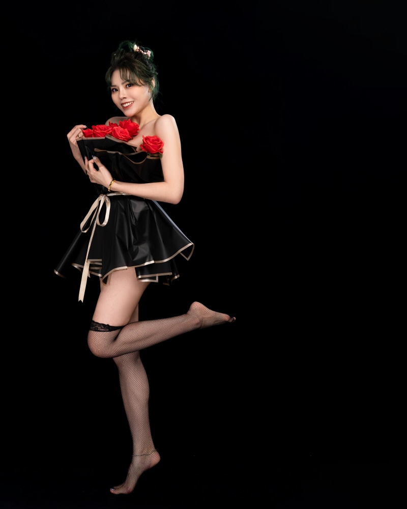 Woman in black dress holding roses