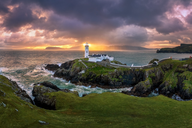 Fanad Lighthouse on the coast of Ireland at sunset