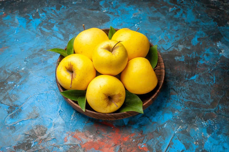 Yellow Apples in a Wooden Bowl