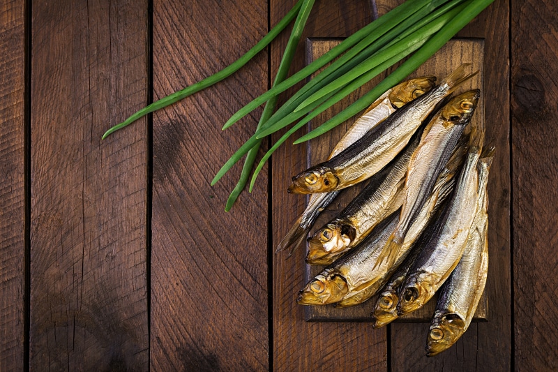 Smoked fish and scallions on wood planks