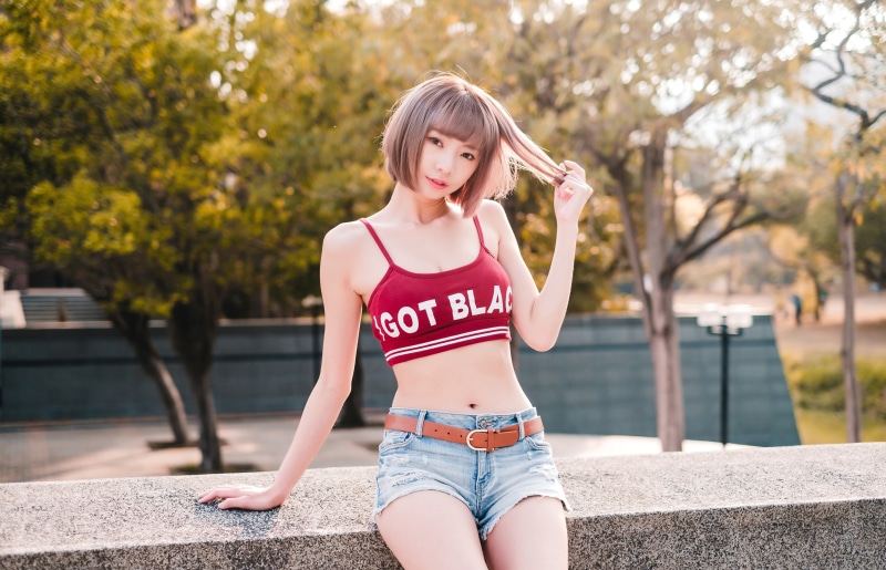 Asian woman in crop top and shorts