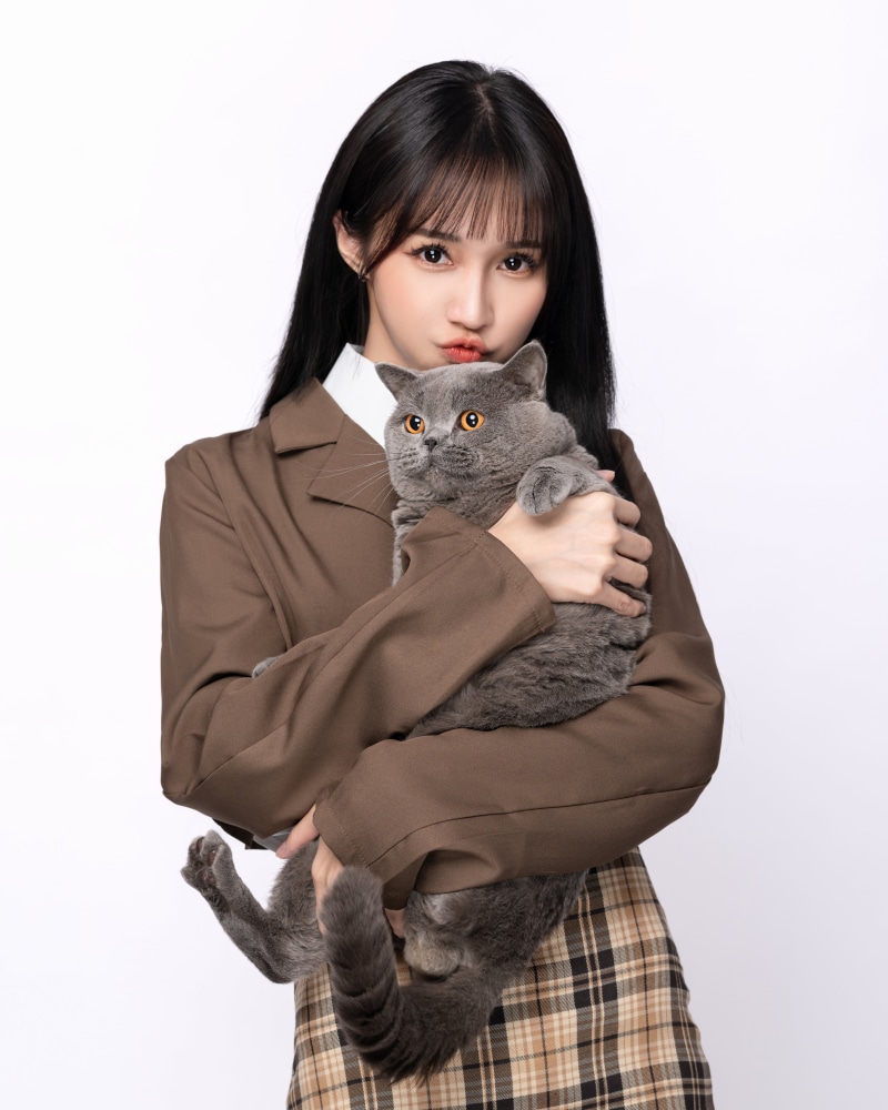 Asian girl with cat in suit jacket