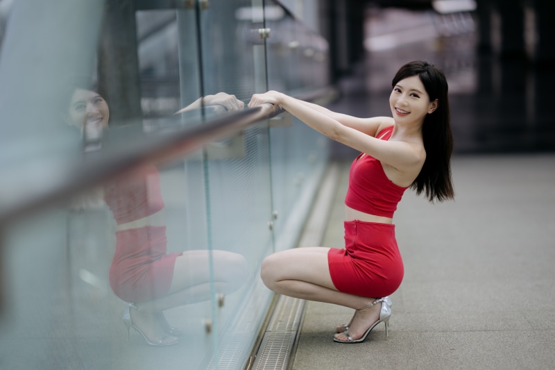 Asian woman in red outfit posing