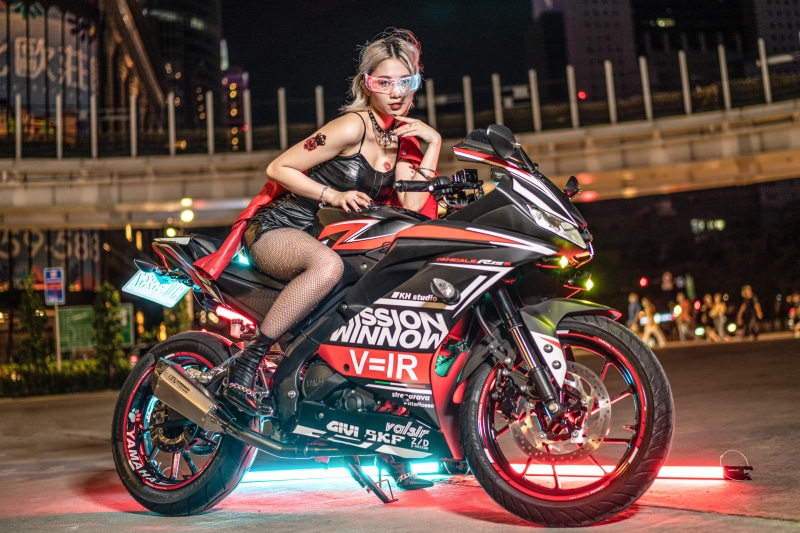 Asian woman in glasses on a Yamaha motorcycle