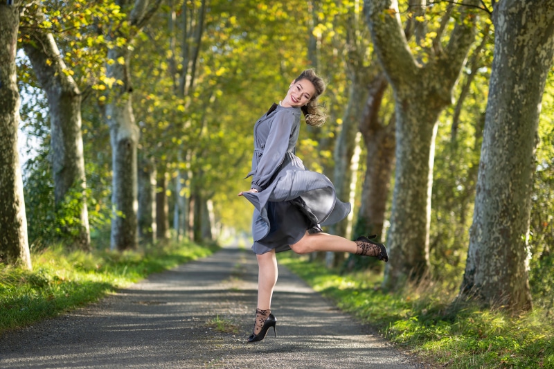 Aleksandra jumping on an avenue