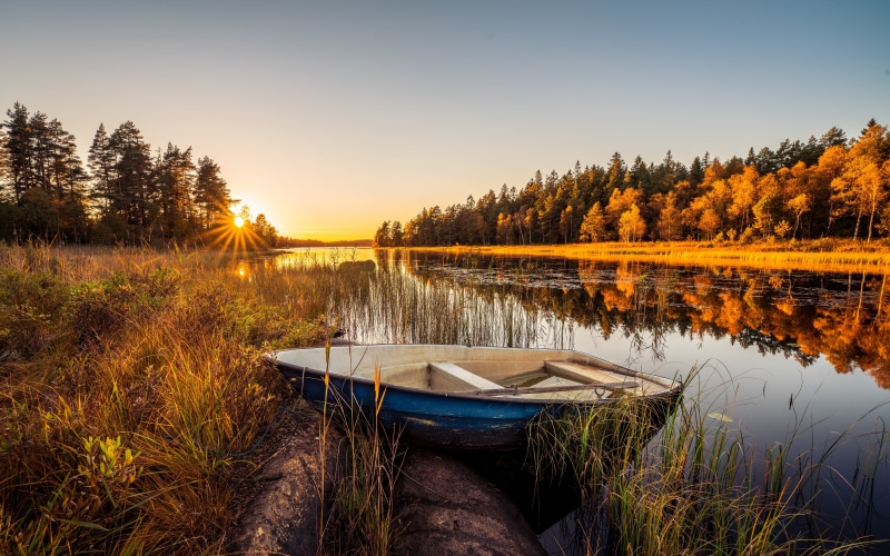 Autumn Sunset over a Swedish Lake with a Boat