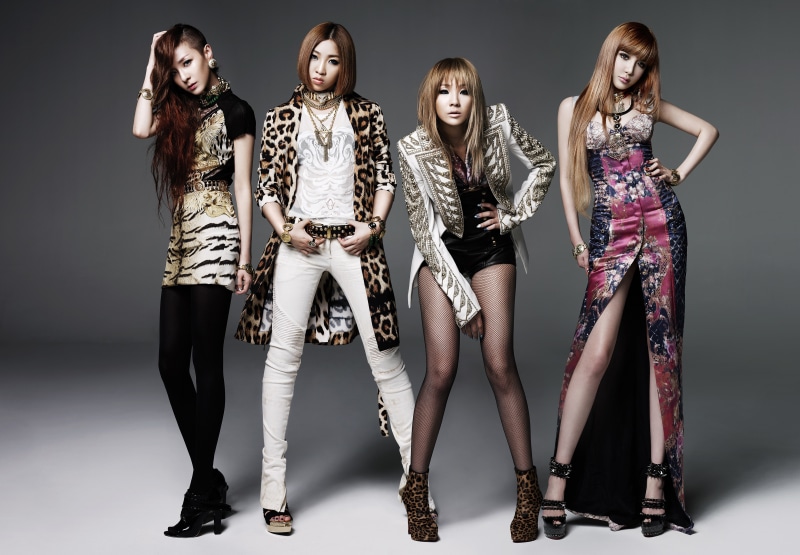2NE1 members posing in fashionable outfits