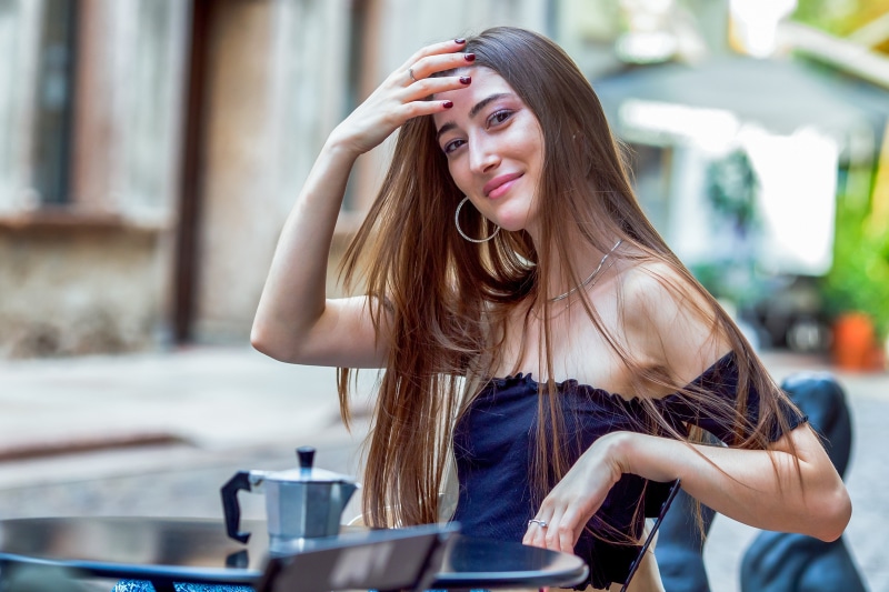 Woman with long brown hair at a cafe