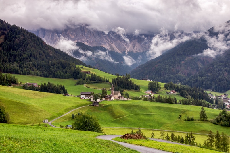 Village in the Italian Alps with Mountains and Clouds