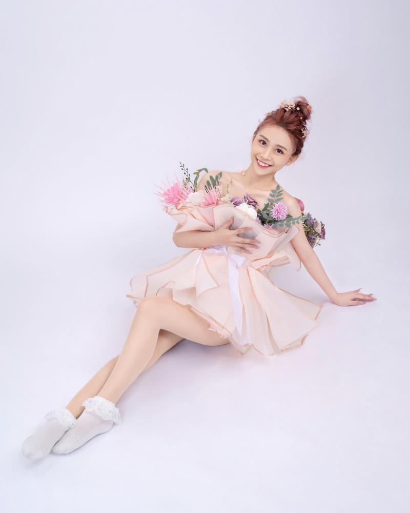 Asian woman sitting with flowers and white socks