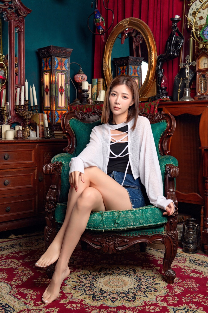 Asian woman sitting in an armchair