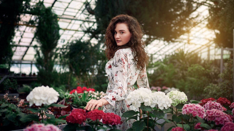 Alice Musina in a floral dress among hydrangeas