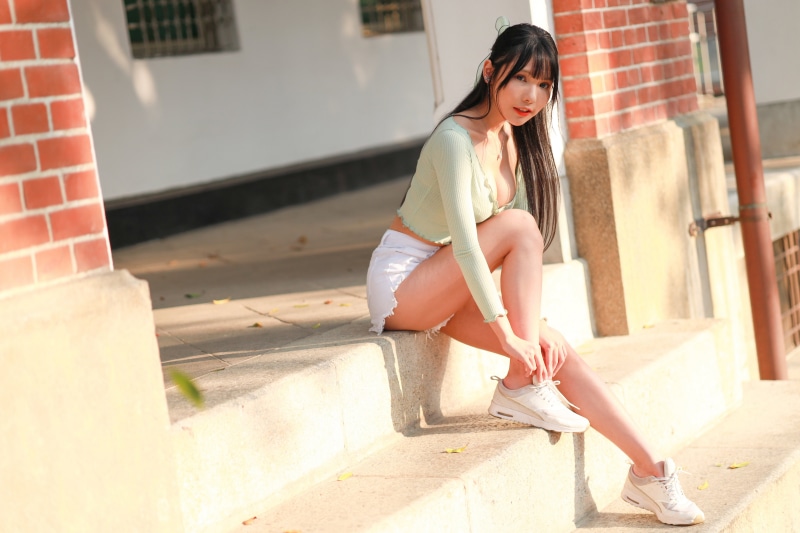 Asian woman sitting on stairs