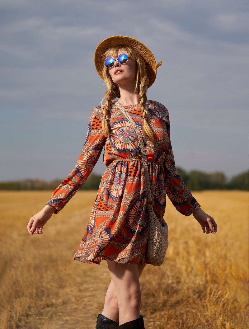 Blonde girl in a patterned dress and hat
