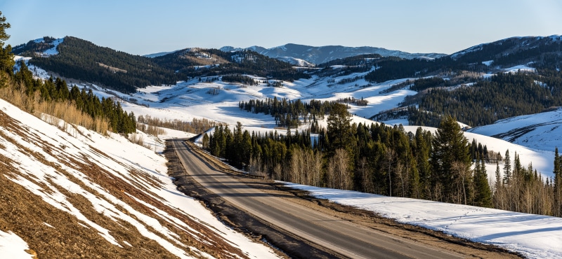 Road through snowy mountains in Wyoming, USA