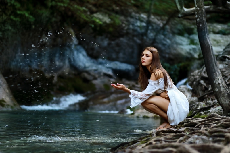 Tonya Smirnova by a stream with water splashes