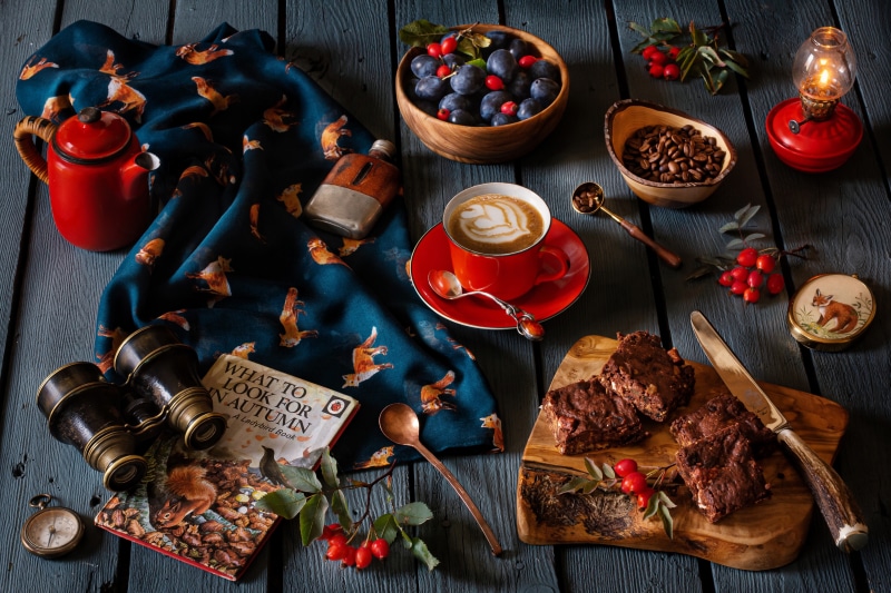 Autumn still life with coffee, brownies, and books