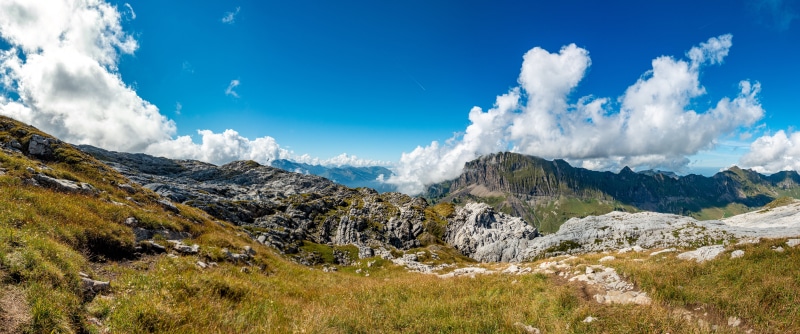 Panorama of Swiss Alps with Mountains and Clouds