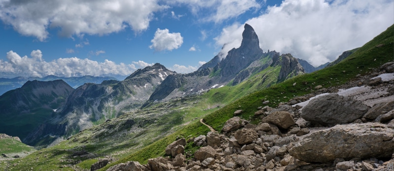 Mountain landscape with sharp peak and clouds in Savoie, France