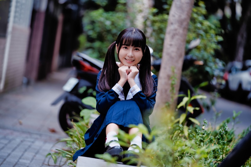 Asian schoolgirl with pigtails smiling