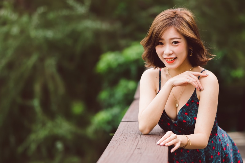 Asian woman with brown hair in a dress