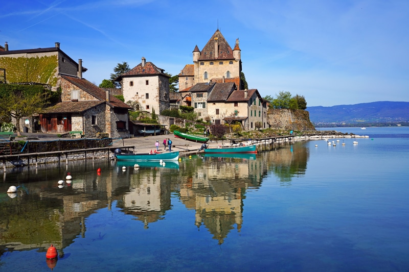 Castle on a lake with boats and reflections