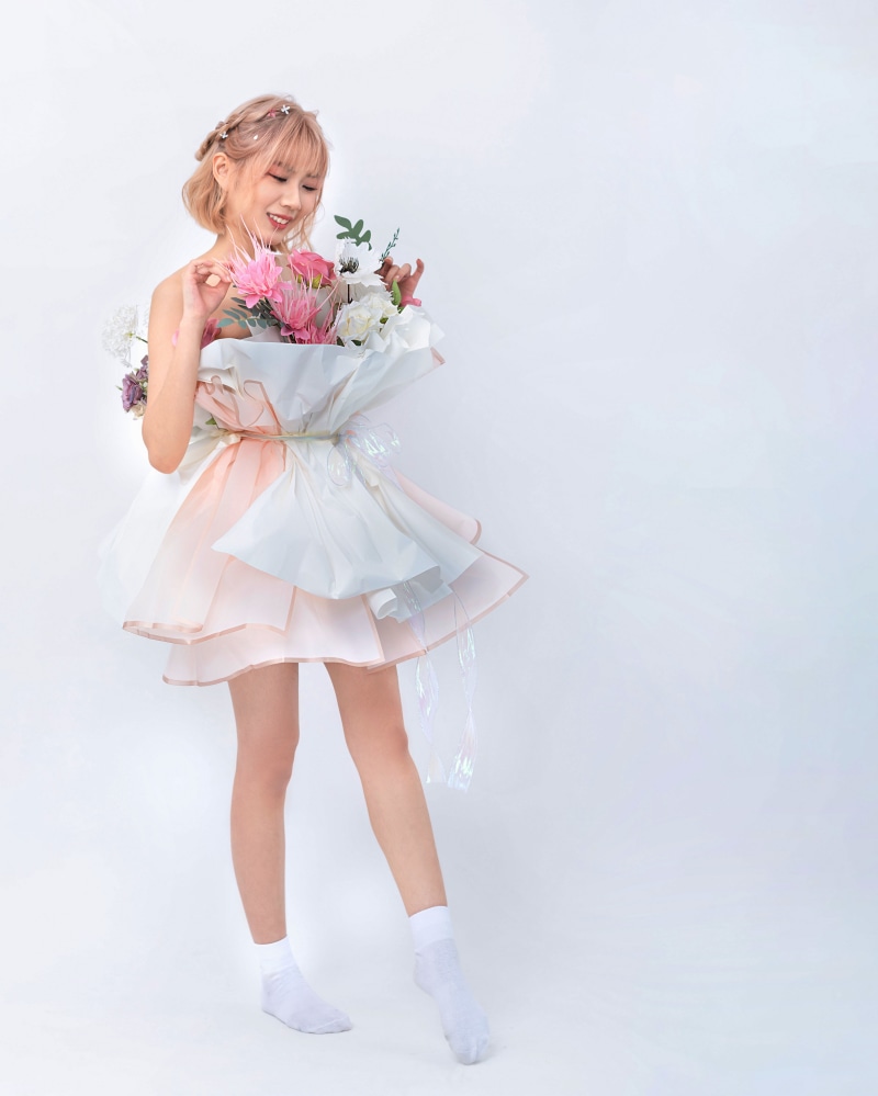 Asian girl in dress holding flowers