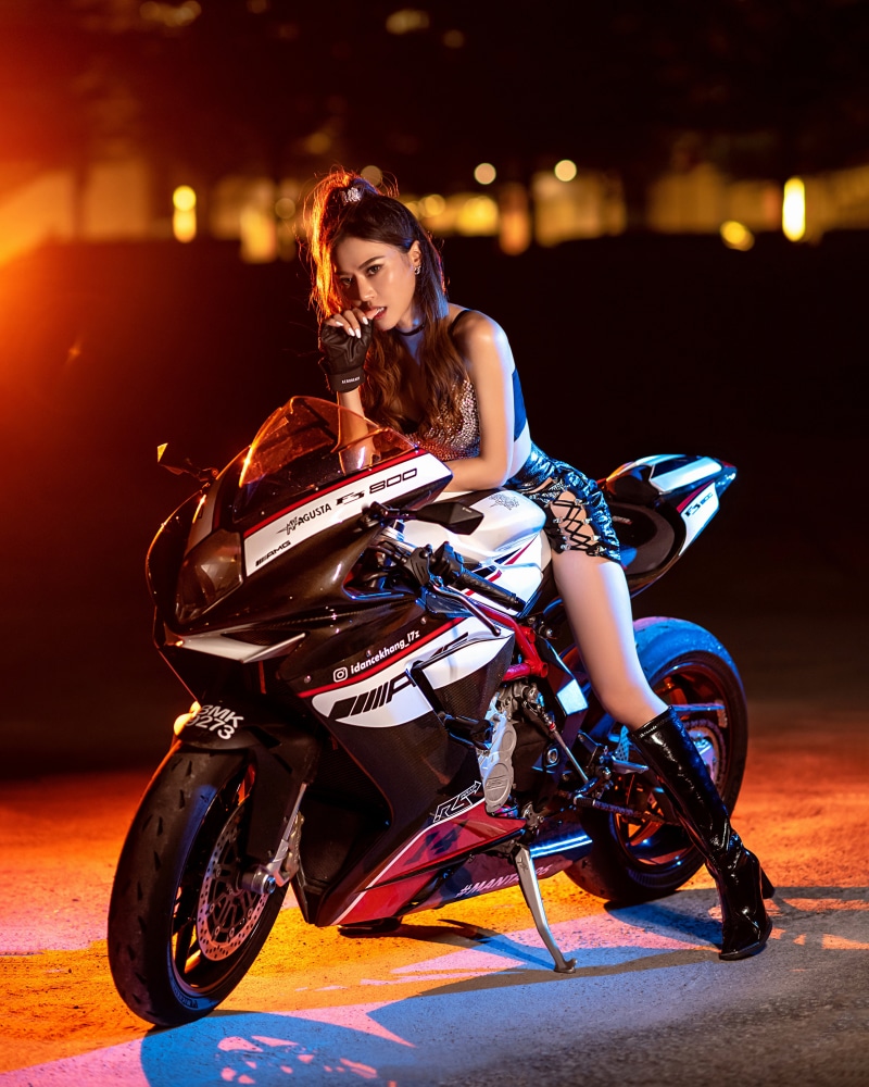 Woman in sparkly top and skirt on a motorcycle