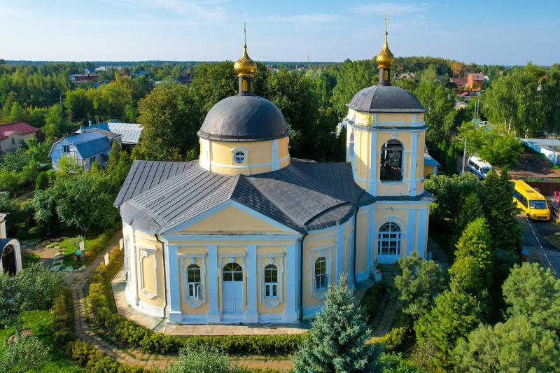 Church with golden domes in Znamenskoye, Russia, from above