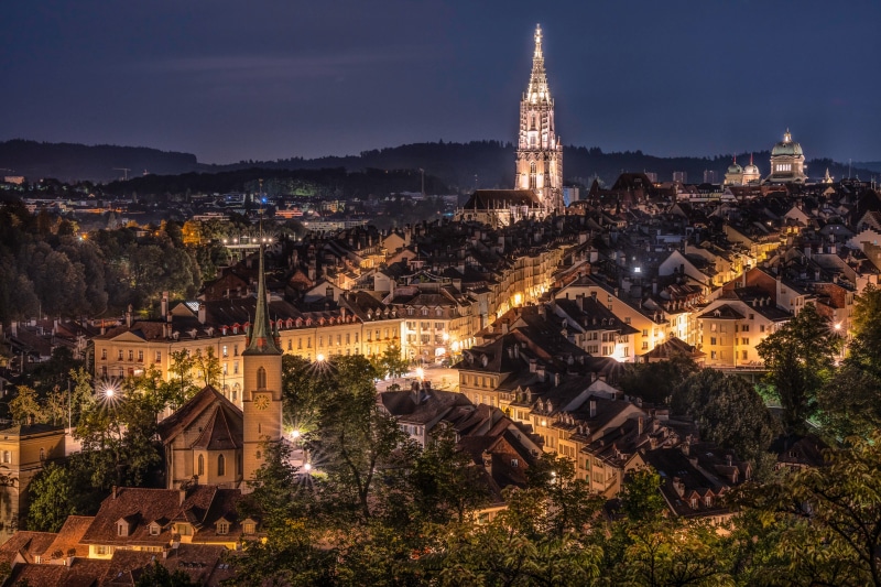 Bern, Switzerland cityscape at night with illuminated buildings