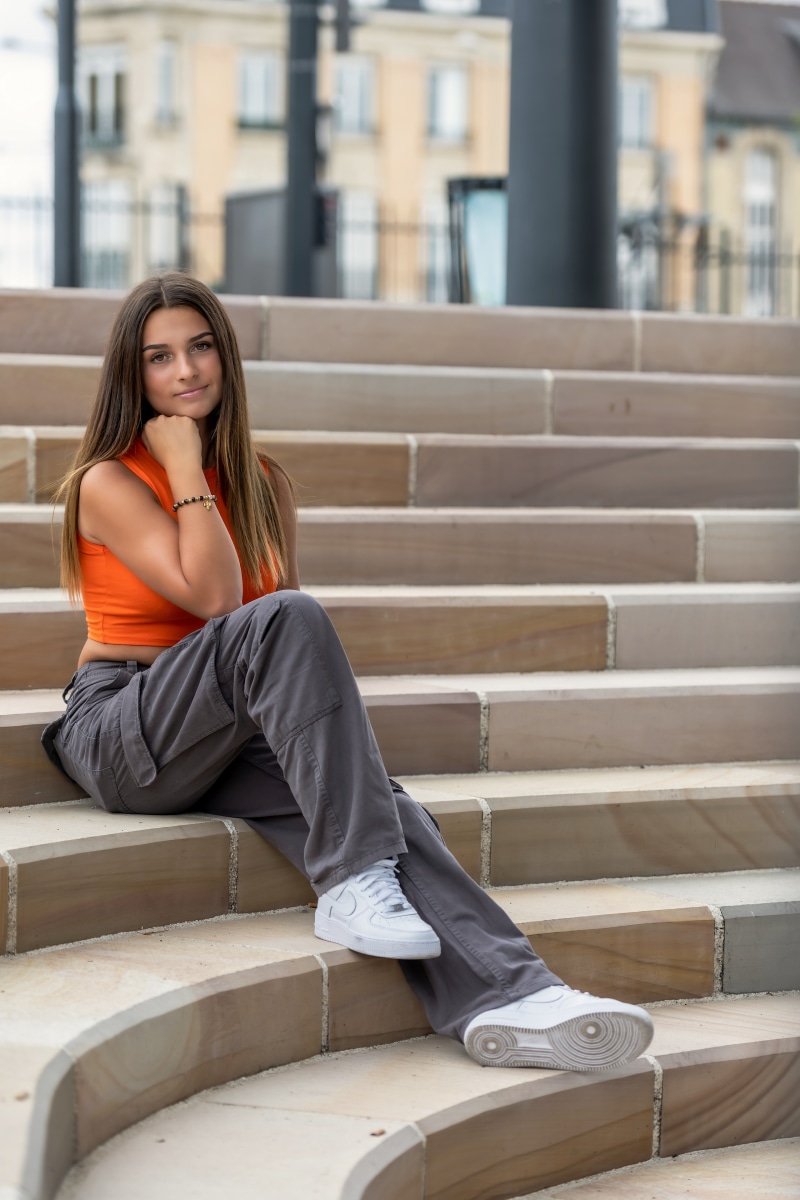 Young woman sitting on outdoor stairs