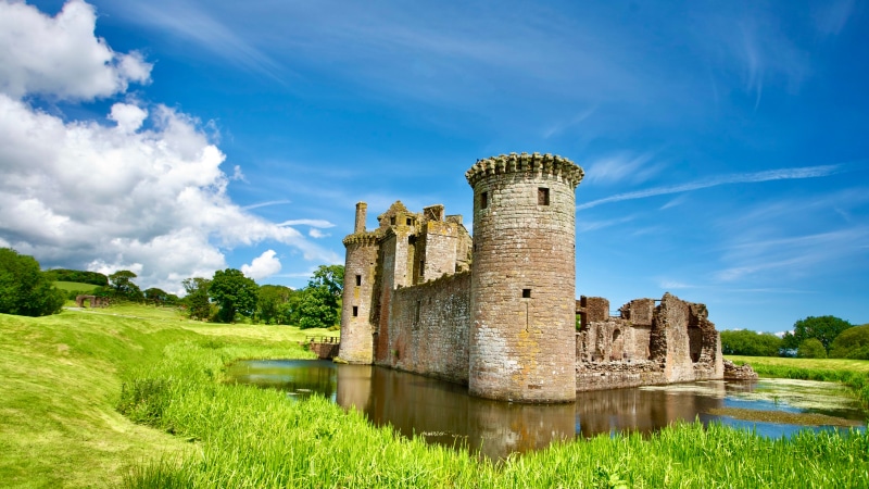 Caerlaverock Castle ruins in Scotland with pond